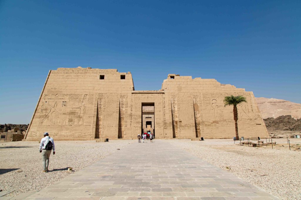 Mohamed walking towards the first pylon in the mortuary temple at Medinet Habu.