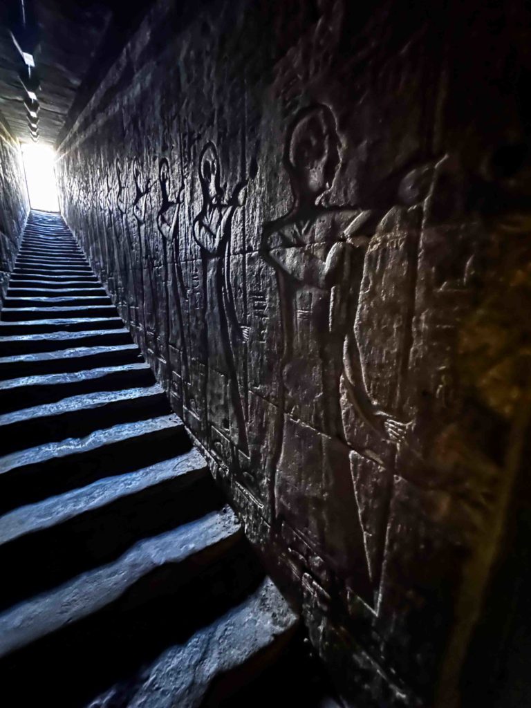 Etchings of priests descending in the Temple of Edfu.